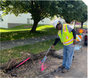 Person marking a utility line with spray paint