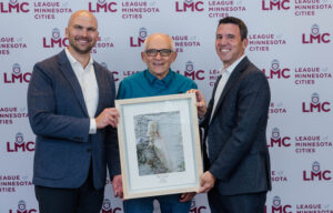 Waite Park Mayor Rick Miller received the 2024 C.C. Ludwig Award. He is shown standing with LMC Executive Director Luke Fischer and LMC President Justin Miller.