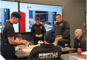 Emergency responders gathered around a table.